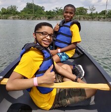 Kids in kayak boats, having fun in After The Peanut's STEAM Education Program at Summer Camp