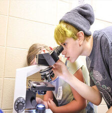 Kids using a telescope, exploring in After The Peanut's STEAM Education Program in STEAM Club